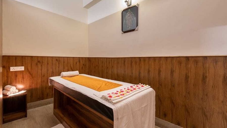 Shot of massage room with a massage table, towels, and candles | DLS Serenity Resort and Spa